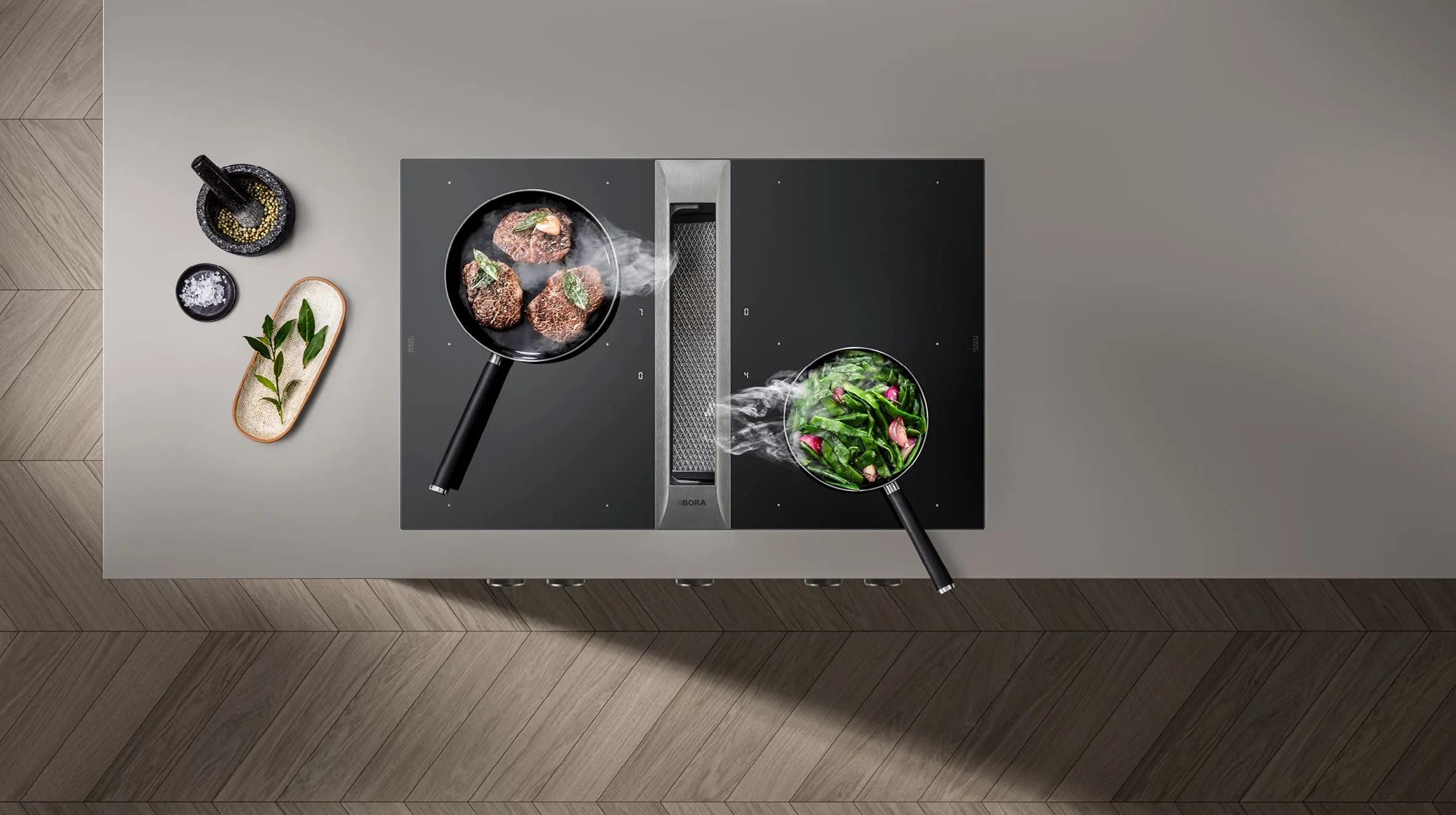 11 (1) BORA Professional 3.0 ploča za kuvanje sa dve posude i integrisanim aspiratorom u sredini, para se diskretno uvlači tokom pripreme jela.