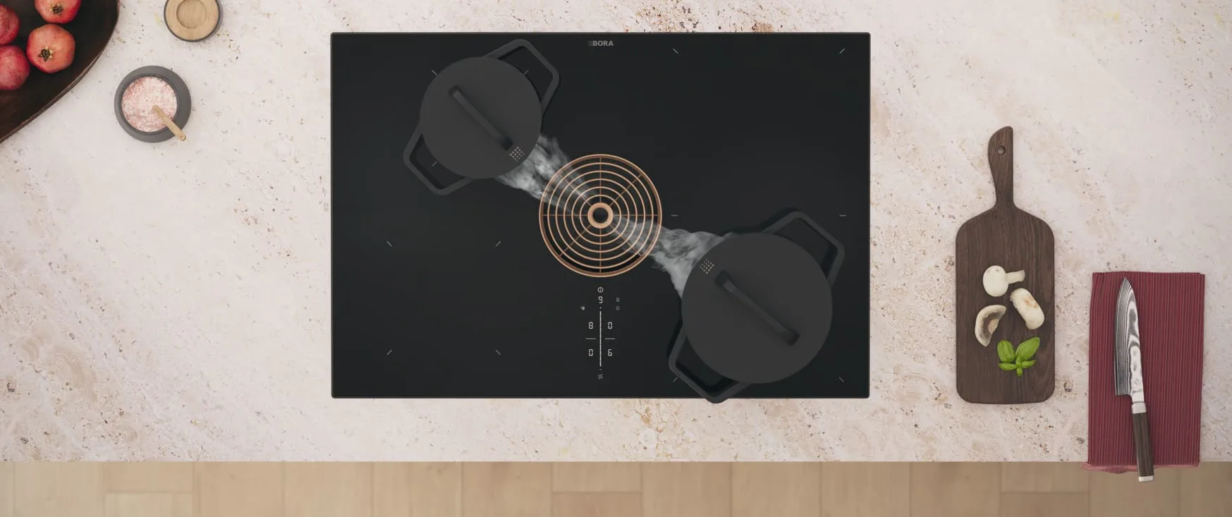 iuyu3hutclq6xj7gpmbt ogled odozgo na BORA M Pure ploču za kuvanje sa integrisanom aspiracijom, dva lonca i elegantnim zlatnim ventilacionim prstenom.